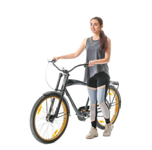 Sporty young woman with bicycle against white background — Stock Photo, Image