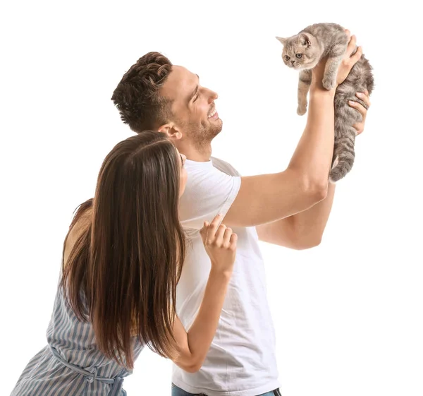 Happy couple with cute cat on white background — Stock Photo, Image