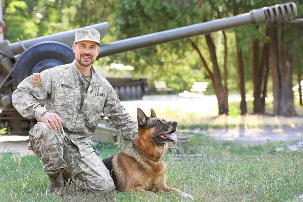 Soldier with military working dog outdoors