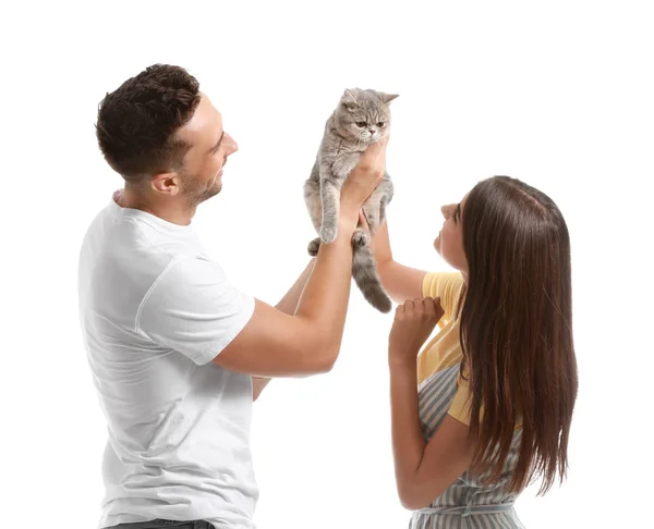Happy couple with cute cat on white background — Stock Photo, Image