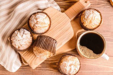 Ahşap masada kahve fincanı ile lezzetli kekler