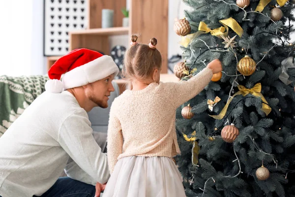 Happy family decorating Christmas tree at home — Stock Photo, Image
