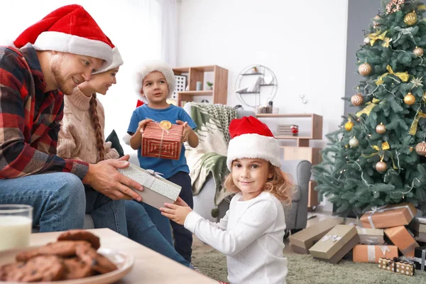 Children greeting their parents on Christmas eve — Stock Photo, Image