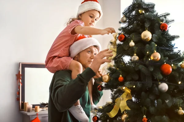 Happy father and daughter decorating Christmas tree at home — Stock Photo, Image