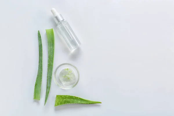 Fresh aloe leaves with essential oil on white background — Stock Photo, Image