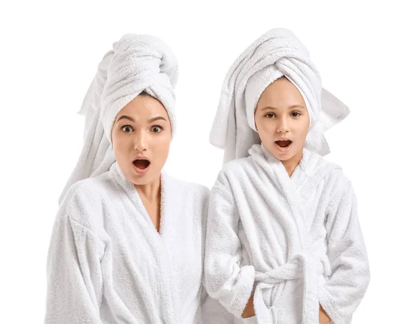 Surprised mother and her little daughter in bathrobes on white background — Stock Photo, Image