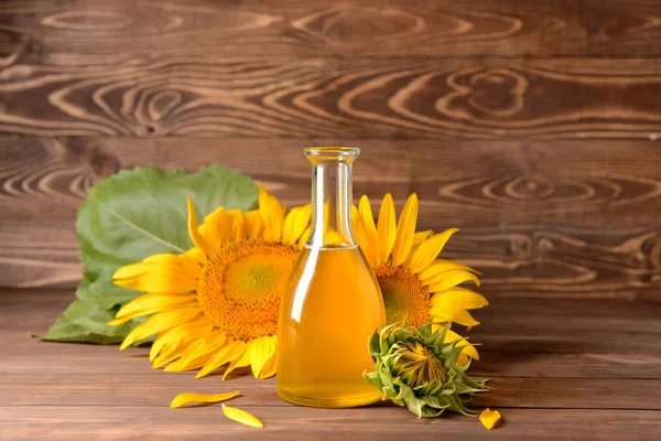 Bottle of sunflower oil on wooden table — Stock Photo, Image