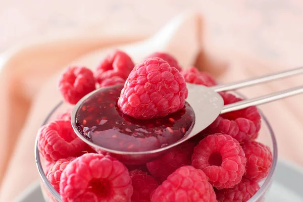 Glass with fresh raspberries and spoon with jam, closeup — Stock Photo, Image