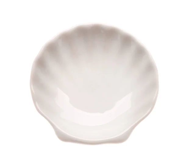 Ceramic plate in shape of seashell on white background — Stock Photo, Image