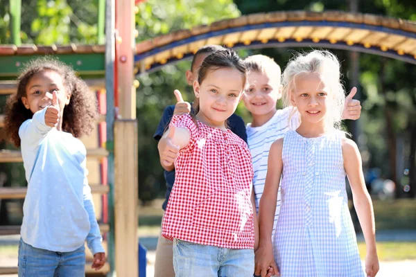 Cute little children showing thumb-up gesture on playground outdoors — Stock Photo, Image