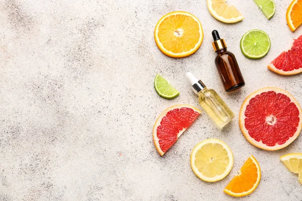 Citrus essential oil on grey background — Stock Photo, Image