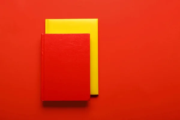 Two books on color background