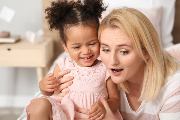 Happy woman with her little African-American daughter at home — Stock Photo, Image