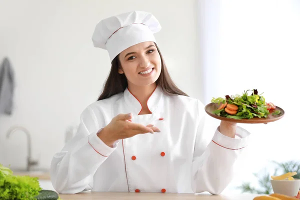 Gyönyörű női séf salátával a konyhában — Stock Fotó