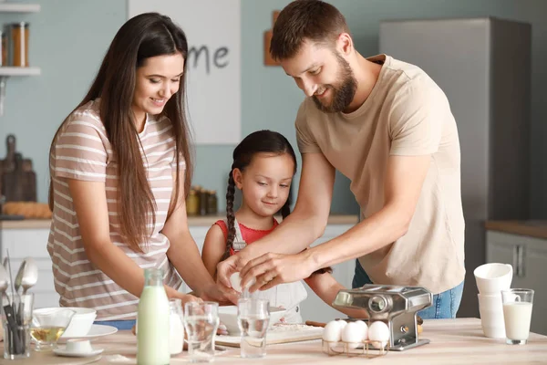 Young family cooking together in kitchen