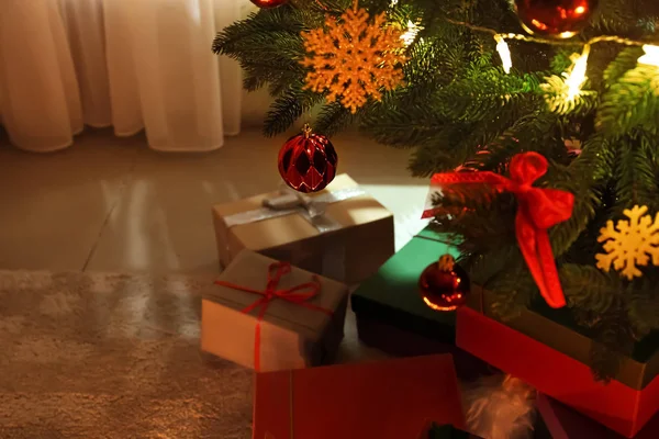 Beautifully decorated Christmas tree with gift boxes in room, closeup — Stock Photo, Image