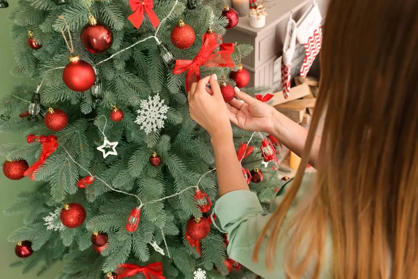 Woman decorating beautiful Christmas tree at home — Stock Photo, Image