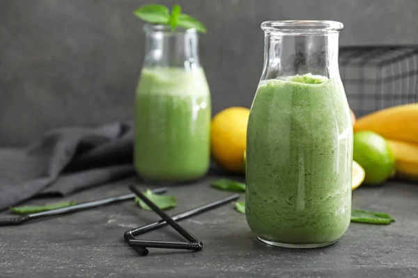 Bottle of healthy smoothie on grey table — Stock Photo, Image