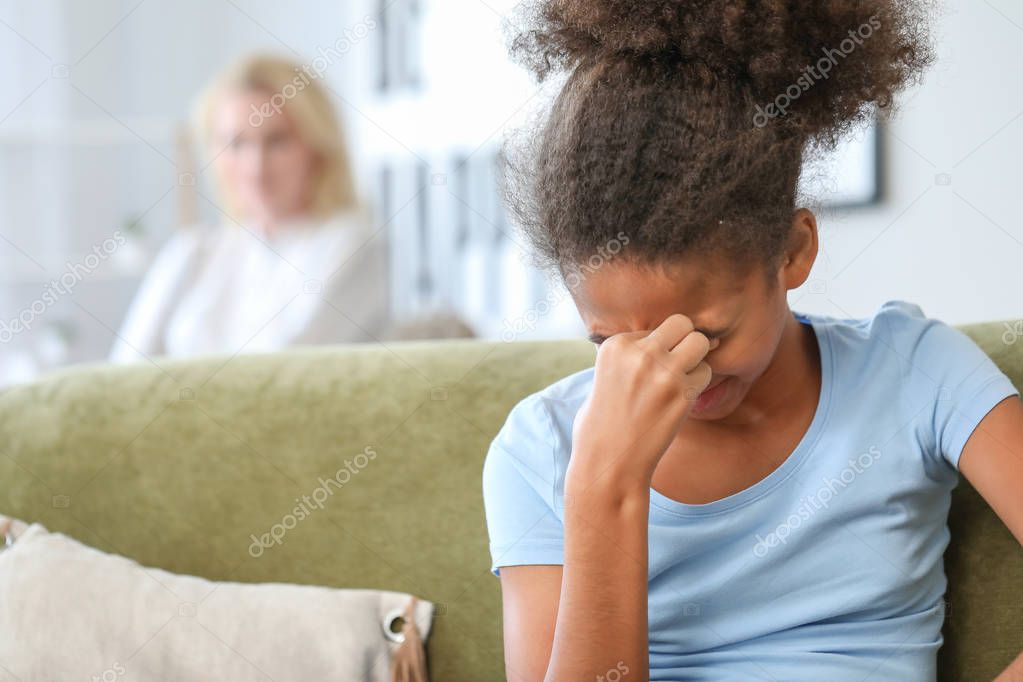 Offended African-American girl after quarrel with mother at home