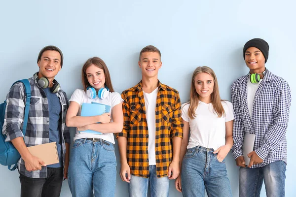 Portrait of young students on color background — Stock Photo, Image