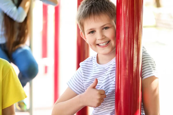 Cute little boy showing thumb-up on playground — Stock Photo, Image