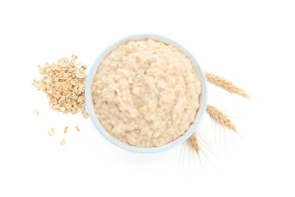 Bowl with tasty oatmeal on white background — Stock Photo, Image