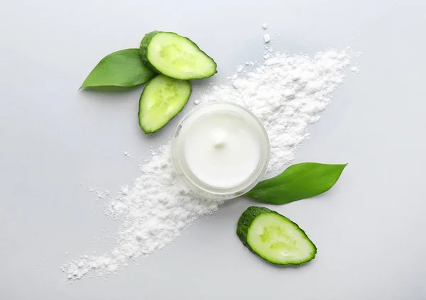 Jar of body cream and cucumber slices on white background — Stock Photo, Image