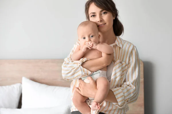 Happy mother with cute little baby at home — Stock Photo, Image