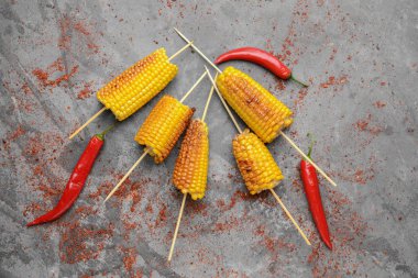 Grunge arka planda lezzetli ızgara mısır koçanları ve biber