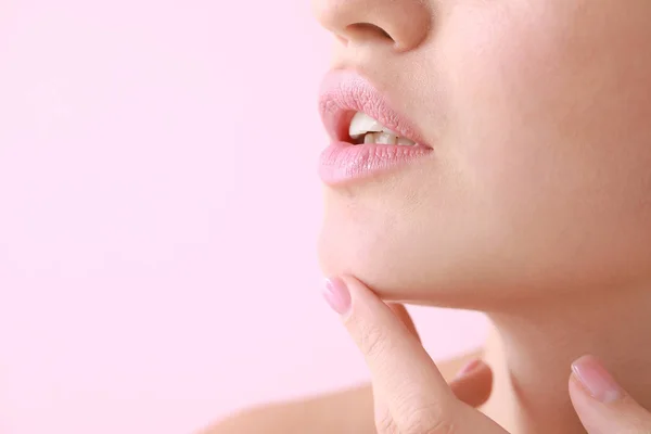 Mujer joven con hermosos labios sobre fondo de color, primer plano — Foto de Stock