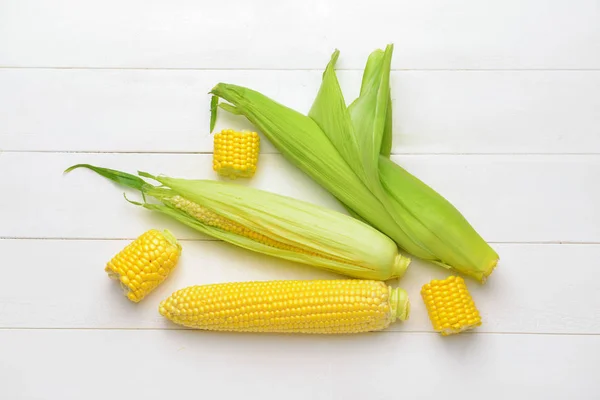 Свежая кукуруза на белом деревянном фоне — стоковое фото