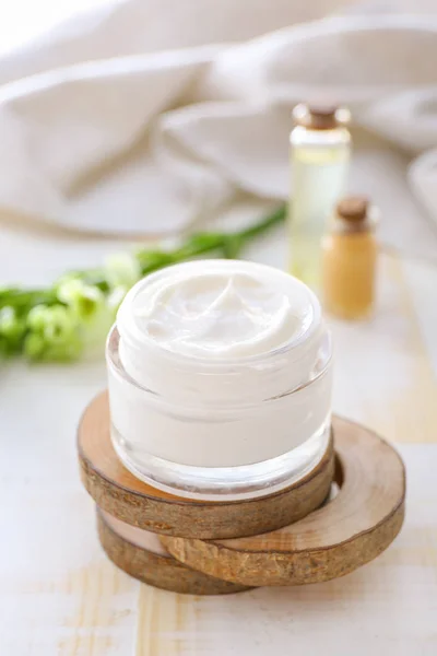 Jar of natural cream on light background