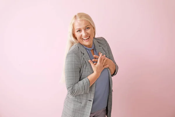Happy mature woman on color background