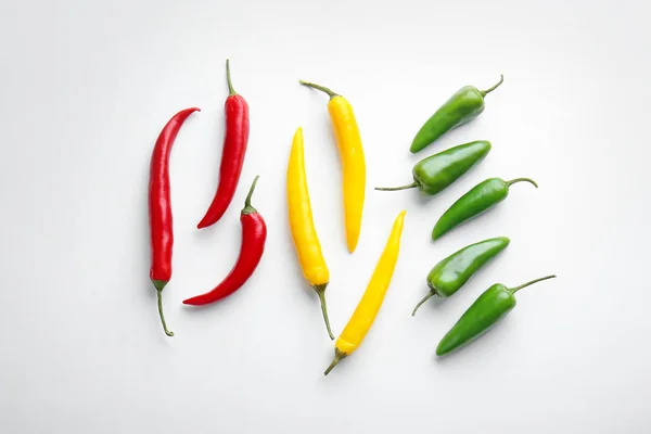 Different fresh chili peppers on white background — Stock Photo, Image