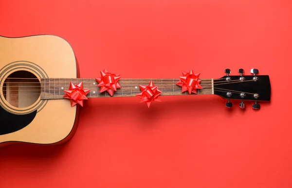 Guitar and Christmas decor on color background Stock Photo by ©serezniy  294134446