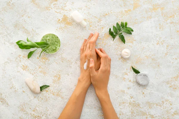 Female hands with natural cream on light background — Stock Photo, Image