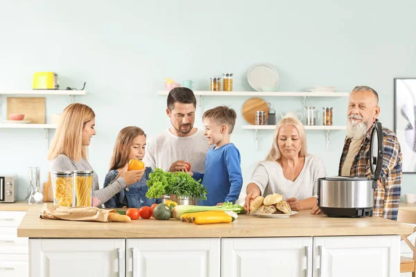 Happy family with modern multi cooker in kitchen — Stock Photo, Image