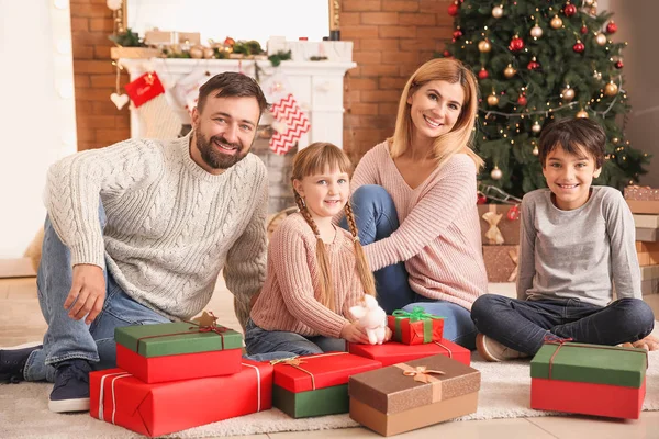 Happy family with Christmas gifts at home — Stock Photo, Image