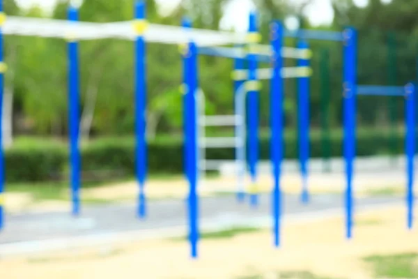 Blurred view of monkey bars on playground in park — Stock Photo, Image
