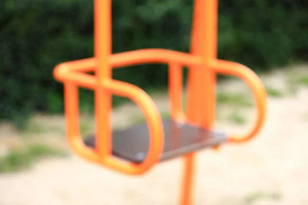 Blurred view of swing on playground in park — Stock Photo, Image