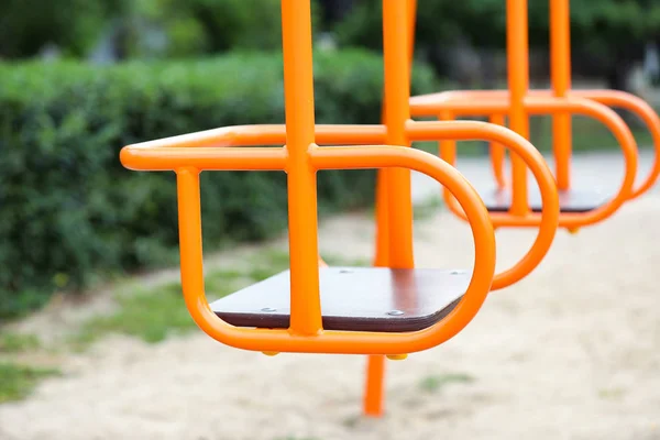 Swings on playground in park — Stock Photo, Image