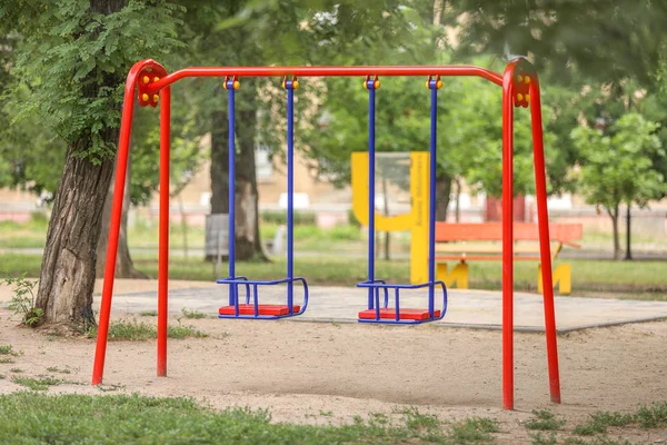 Swings on playground in park — Stock Photo, Image