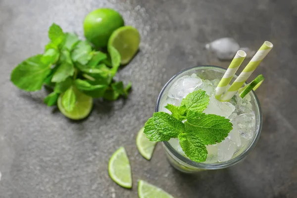 Glass of fresh mojito on grunge table — Stock Photo, Image