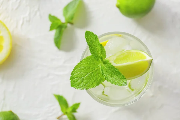 Glass of fresh mojito on light table — Stock Photo, Image