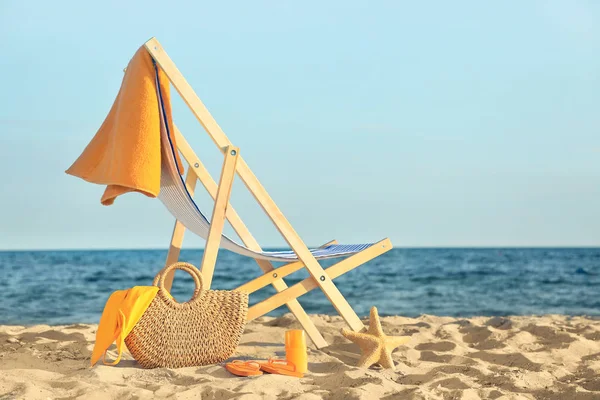 Chair with bag and accessories on sand beach — Stock Photo, Image