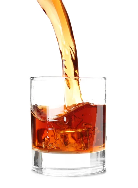 Pouring of whiskey into glass on white background — Stock Photo, Image