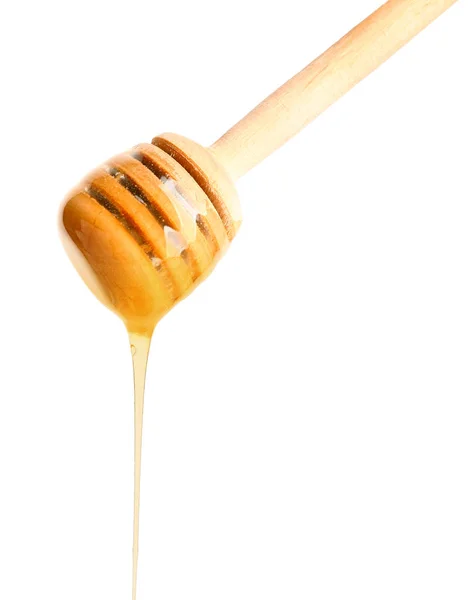 Dřevěné honey naběračka na bílém pozadí — Stock fotografie