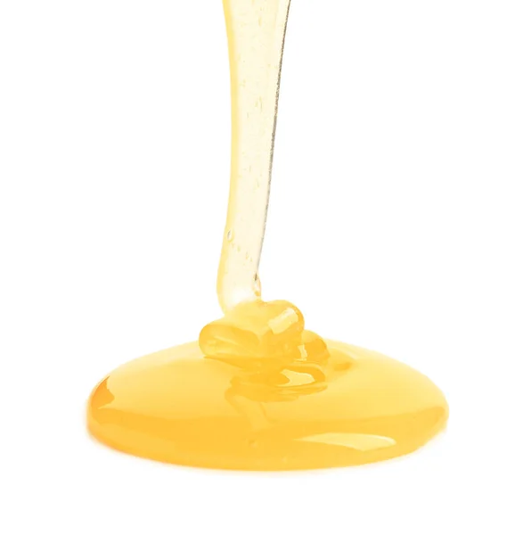 Derramando mel no fundo branco — Fotografia de Stock