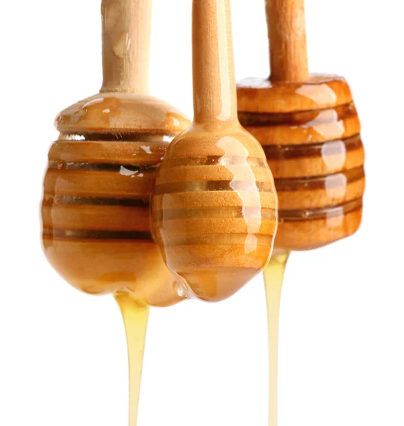 Wooden honey dippers on white background — Stock Photo, Image