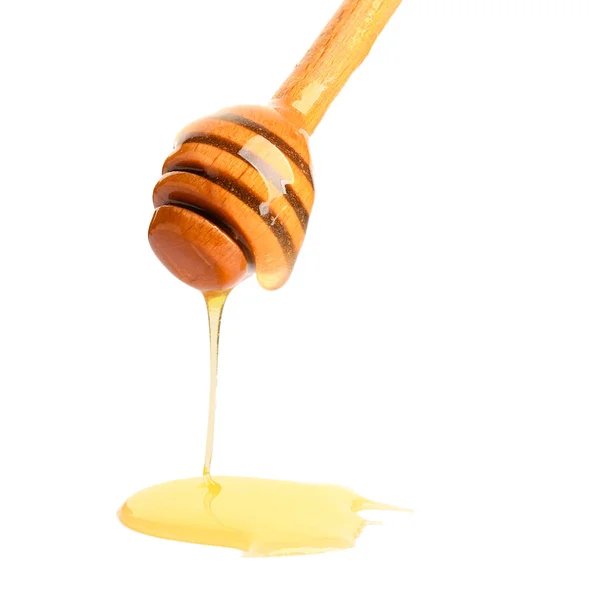 Dřevěné honey naběračka na bílém pozadí — Stock fotografie